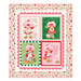Patchwork quilt with four Strawberry Shortcake illustrations and floral border.