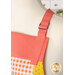 A super close up shot of the strap of the apron, demonstrating the adjustable closure and fabric details.