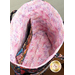 A top down shot of the inside of the bag, showing details on the lining fabric and interior pocket.