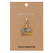 enamel charm featuring a blue floral, decorative enamel sewing machine with a lobster claw clasp attached to its brown packaging