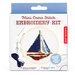 The Mini Cross Stitch Embroidery Kit packaging featuring a red, white, and blue sailboat