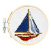 Digital image of a completed cross stitch sailboat isolated on a white background.