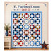 Mockup of the completed E. Pluribus Unum Quilt, a patchwork of dynamic shapes in patriotic colors, staged on a cream shiplap wall with coordinating décor.
