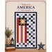 Mockup of the completed wall hanging, a patchwork flag of dynamic shapes in patriotic colors on a cream background with the name of quilt.