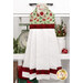 The completed Hanging Towel colored in red, cream, and mint green fabrics from the Evergreen Wishes collection by Riley Blake Designs, staged on a kitchen drawer with coordinating decor.