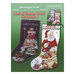 Front cover of the cross stitch pattern with the finished stockings on a green background.