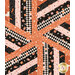 A top down shot of the mesmerizing patchwork of the topper's center, demonstrating details on the orange, pink, black, and cream fabrics.