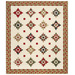 The completed North Star Quilt, colored in cream, red, green, and black fabrics from the Candlelight Christmas collection by Moda Fabrics, isolated on a white background. 