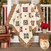 The completed North Star Quilt, colored in cream, red, green, and black fabrics from the Candlelight Christmas collection by Moda Fabrics, artfully draped over a white porch railing and staged with coordinating florals, holiday décor, and furniture.