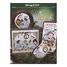 Front cover of the cross stitch pattern with the finished projects staged on a green festive background.