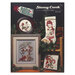 Front cover of the cross stitch pattern with the finished projects staged on a decorated background.