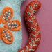 Close up on the cat's cute tail, demonstrating embroidery details.