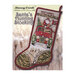 Front cover of the pattern booklet showing the finished stocking displayed on a snow-covered wheat field background.