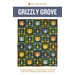 front cover of the Grizzly Grove featuring a navy quilt with alternating squares of bear heads and pine trees in shades of orange, gold, chartreuse, and blue,