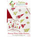 front of the Snowy Pines Table Runner pattern featuring festive Christmas trees in red and green prints with coordinating stars on a snowy white background.