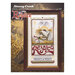 Front cover of the cross stitch pattern with the finished design framed and staged in a manger.