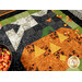 An angled, stylized shot of the block, staged with a bowl of candy corn as well as a handful of tossed candy corn.