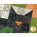A super close up on the head of the cat, demonstrating fabric colors and print details as well as top quilting effects.