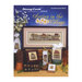 Cover of Spring in the Village cross-stitch book featuring framed artwork and decorative items.