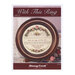 Front cover of the With This Ring cross stitch pattern with the finished design in a wooden circle frame in front of a lace fabric.