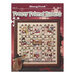 Front cover of the cross stitch pattern with the finished project staged on a red background.