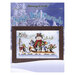 Front cover of the cross stitch pattern with the finished project staged on a snowscape background.