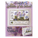 Front cover of the cross stitch pattern with the finished project shown in an enlarged version and a version on a magnet board.
