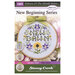 Front cover of the cross stitch pattern with the finished project shown in a hoop with a green bow.
