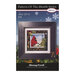 Front of the Pattern of the Month Series Joy cross stitch pattern with the finished design in a black wooden frame isolated on a wintry scene.
