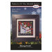 Front of the Pattern of the Month Series Rejoice cross stitch pattern with the finished design in a black wooden frame isolated on a wintry scene.