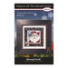 Front of the Pattern of the Month Series Believe cross stitch pattern with the finished design in a black wooden frame isolated on a wintry scene.