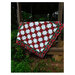 The completed project in red, white, and green fabrics, staged on a woodsy gazebo.