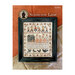 Front cover of the Scarecrow Lane cross stitch pattern finished in a black frame and laid on an orange and brown backdrop.