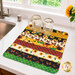 The completed Dry Ideas drying mat, colored in vibrant prints from the Sunshine Whispers collection by Wilmington Prints, staged on a marble kitchen counter with coordinating decor and two bell jars with handles showing scale.