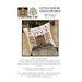 Front of pattern showing the completed cross stitch on a small ornament pillow staged on a floral fabric.
