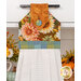 A head-on close up on the top section of the towel, showing details on the fabric as well as the fabric button.