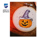 A close up on the jack-o'-lantern project, staged on a rustic wood surface.