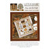Front of pattern showing the completed cross stitch on a small ornament pillow staged on a table by autumnal sprigs.