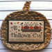 All Hallows Eve cross stitch finished project in a decorative bowl.