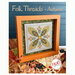Front of pattern showing the completed cross stitch designs displayed on a table with coordinated décor.