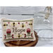 Hope cross stitch pattern displayed on a white wood background. 