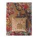 Finished cross stitch fall sampler pillow laid on a charcuterie board surrounded by fall leaves.