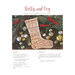 Finished Holly and Ivy stocking placed on pine sprigs, ornaments, a wooden table, and red cardinals.