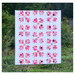 Finished Bear Hugs quilt staged in front of a grassy area.