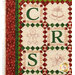 A closer look at the quilt, showing details on the appliqué letters C, R, and S, as well as the hand embroidered bells, gingerbread man, and star.
