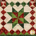A super close up on the pinwheel star patchwork block, showing fabric colors, details, and top quilting effects.