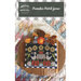 The front cover of the pattern showing finished project decorated on a pumpkin-shaped board.