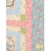 A close up on the sashing of the quilt, demonstrating fabric colors and print details.