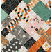 A close up on the patchwork of the quilt, demonstrating fabric prints and color details as well as top quilting effects.