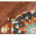 A close up of the edge of the round hot pad, showing details on the binding as well as the fabric loop.